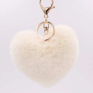 Close-up of fluffy off-white heart plush keychain with elegant golden metal lobster clasp