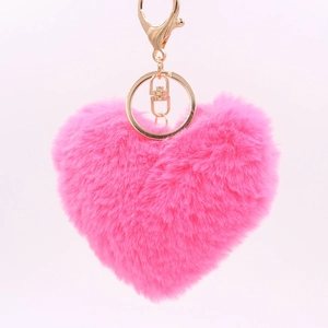 Detailed view of pink heart-shaped plush keychain with golden lobster clasp and ring