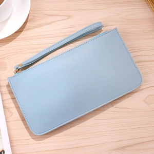 Light blue contrast long wallet with textured faux leather and gold zipper on wooden desk