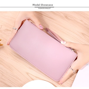 Close-up of pink litchi grain leather long wallet with wrist strap and metal zipper
