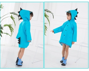 Detail of blue kids dinosaur raincoat featuring unique back spikes and a clear hood brim