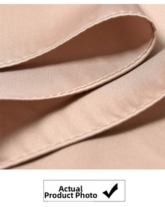 Macro shot of fine plain weave texture and double-stitched edge on the brown silk scarf