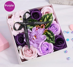 Detailed view of purple soap flower gift box with rose floral arrangements and ribbons