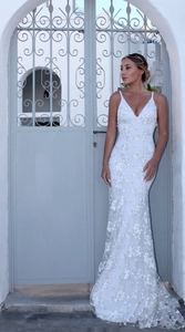 Detail of white lace wedding dress with V-neckline and intricate floral embroidery