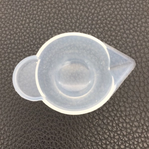 Top view of a translucent heart-shaped silicone mixing cup with a pour spout for DIY resin art