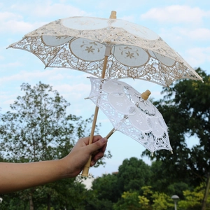 Elegant white lace wedding umbrella set with floral embroidery and natural wooden handles