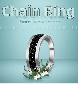 Detail of silver titanium steel ring with an integrated rotatable black chain inlay