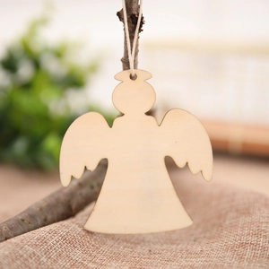 Macro detail of natural wood angel ornament hanging on a branch for Christmas decor