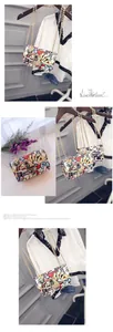 Detail of graffiti print crossbody bag featuring playing card motifs and gold chain