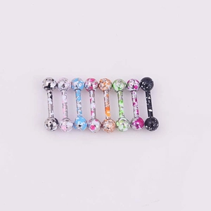 Close-up of colorful paint-splattered stainless steel studs for ear or body piercing
