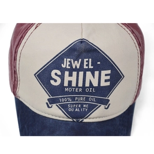 Close-up of vintage tricolor cotton baseball cap featuring retro motor oil logo patch