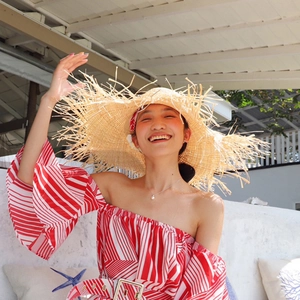 Fashionable straw beach hat with fringe edges and sun protection for summer outdoor travel