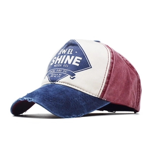Close-up of vintage American style color-block baseball cap with embroidery and distressed brim