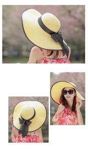 Dettaglio di un cappello di paglia beige con tesa larga ed elegante fiocco in nastro nero
