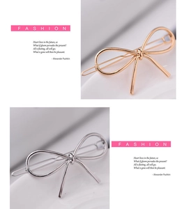 Detail showing polished gold and silver metal bow hair clips in a fashion style