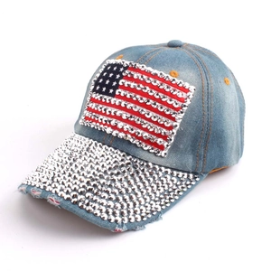 Detail of light blue denim baseball cap with American flag and shiny rhinestones