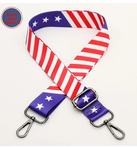 Detail of wide American flag pattern bag strap with gunmetal swivel hooks and adjustable buckle