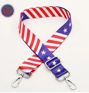 Close-up of adjustable wide woven bag strap featuring a red white and blue star pattern