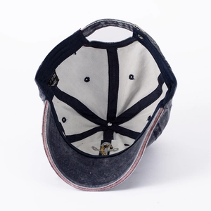 Internal view of grey washed denim baseball cap featuring reinforced seams and embroidery