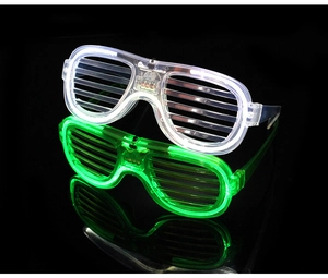 Macro detail of white and green LED shutter glasses with glowing lights for parties