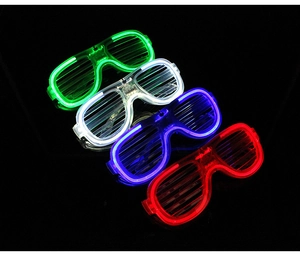 Detailed view of four LED shutter glasses in green, white, blue and red on black background