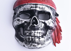 Close-up of a silver pirate skull mask with a red polka dot bandana for Halloween decor