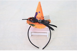 Detail of orange Halloween witch hat headband with black lace and bat prints on a mini bench