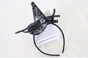 Detail of mini witch hat headband with spider web pattern and black mesh veil for Halloween