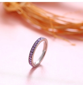 Detailed close-up of a titanium steel eternity ring with purple cubic zirconia stones