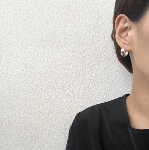 Minimalist wide 925 sterling silver hoop earring shown on a model's ear in close-up