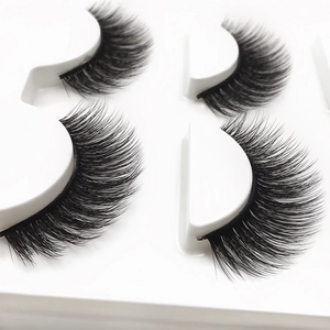 3D thick curly black false eyelashes set on a white professional packaging tray