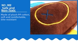 Detail view of plush dog toy fabric with blue cross embroidery and soft PP cotton filling