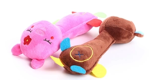 Detail of plush squeaky dog toys in pig and dog shapes with soft texture and durable seams