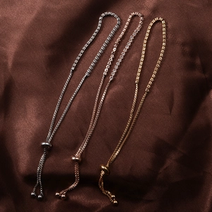 Three adjustable rhinestone claw chain bracelets in silver, gold, and rose gold finish