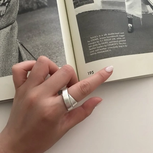 Detail of minimalist 925 sterling silver wide band ring with a matte frosted finish