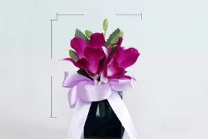 Detail of purple artificial orchid boutonniere with ribbon bow, measuring 8cm by 11cm