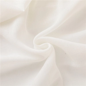 Close-up of white sheer cotton linen fabric with subtle silver glitter and soft fringe