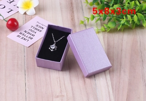 Purple jewelry gift box 5x8x3cm with black sponge insert for necklaces on wooden table