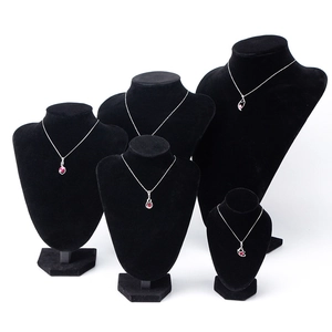 Black velvet necklace bust display set with silver necklaces and red gem pendants