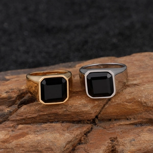 Vintage men's stainless steel signet rings with black square gemstone on wood base