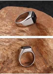 Macro view of men's stainless steel ring featuring a square black onyx inlay on rock