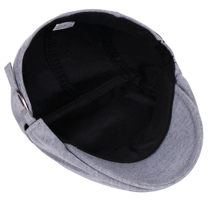 Detailed interior view of grey cotton blend flat cap showing lining and care label