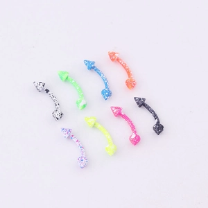 Detailed view of multi-colored curved barbells for eyebrow piercing with snowflake dots
