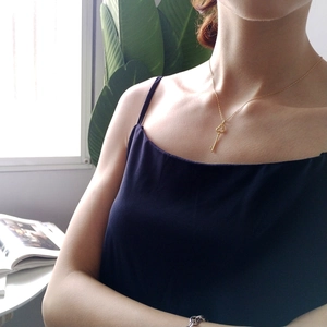 Detailed view of an elegant 925 sterling silver key pendant necklace worn by a model