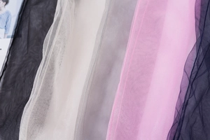Close-up of lightweight transparent mesh fabric in various colors for summer socks