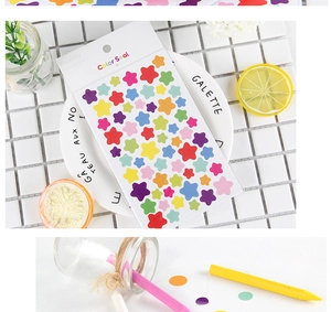 Detail of colorful star-shaped stickers set on white grid with decor for stationery