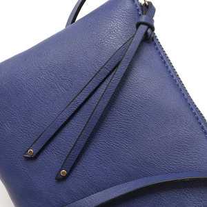 Detail of blue leather envelope clutch with lychee grain texture and tassel zippers