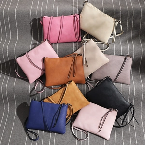 Detailed selection of colorful PU leather crossbody bags with zip closure on striped fabric