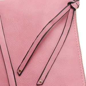 Detailed view of pink faux leather texture with black trim strap and gold stud on a handbag
