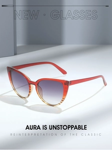 Detail view of retro cat-eye sunglasses with red-orange gradient frames and tinted lenses